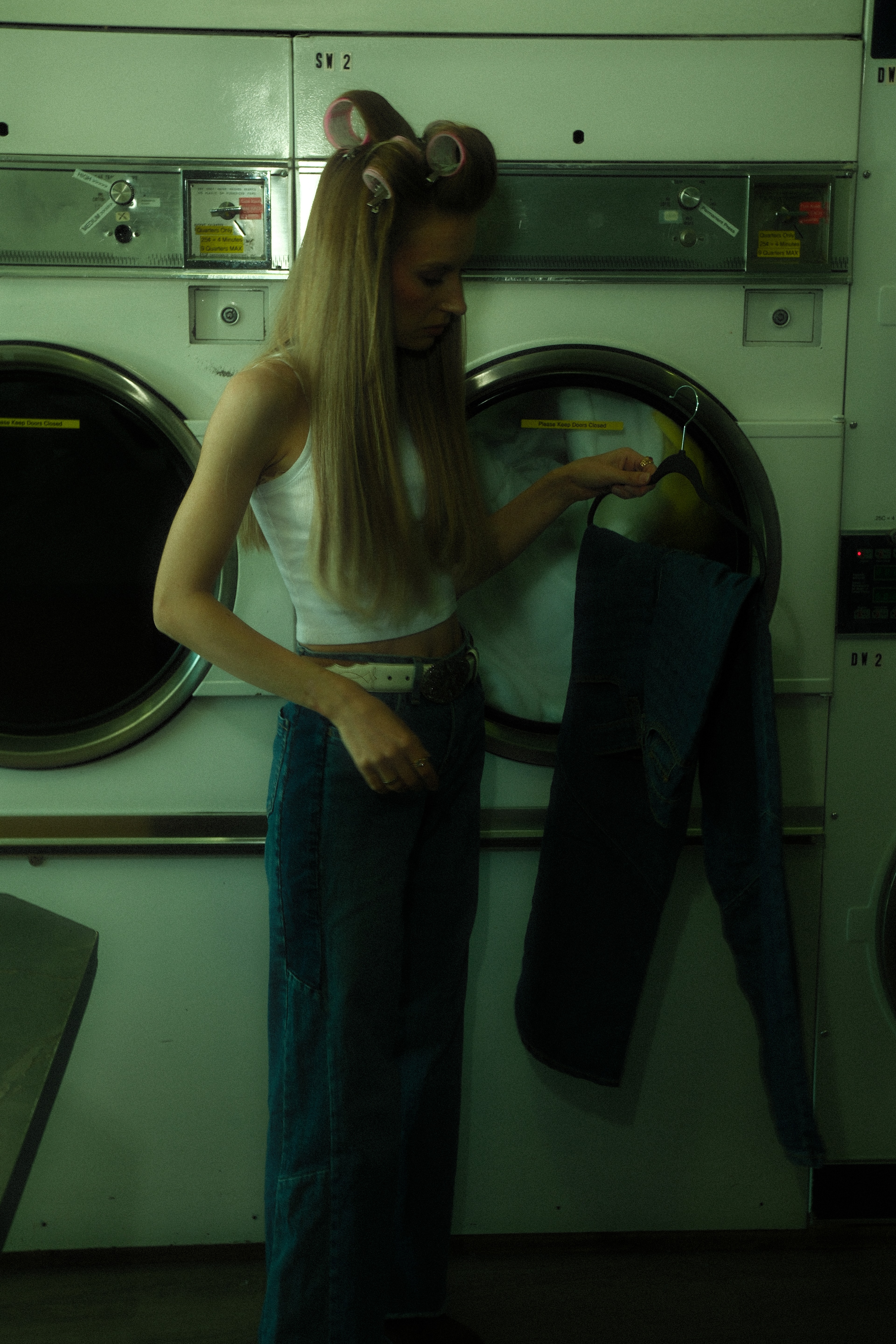 Spin Cycle, Calgary. Denim, fluorescent green light and candid movement inside an everyday laundromat.