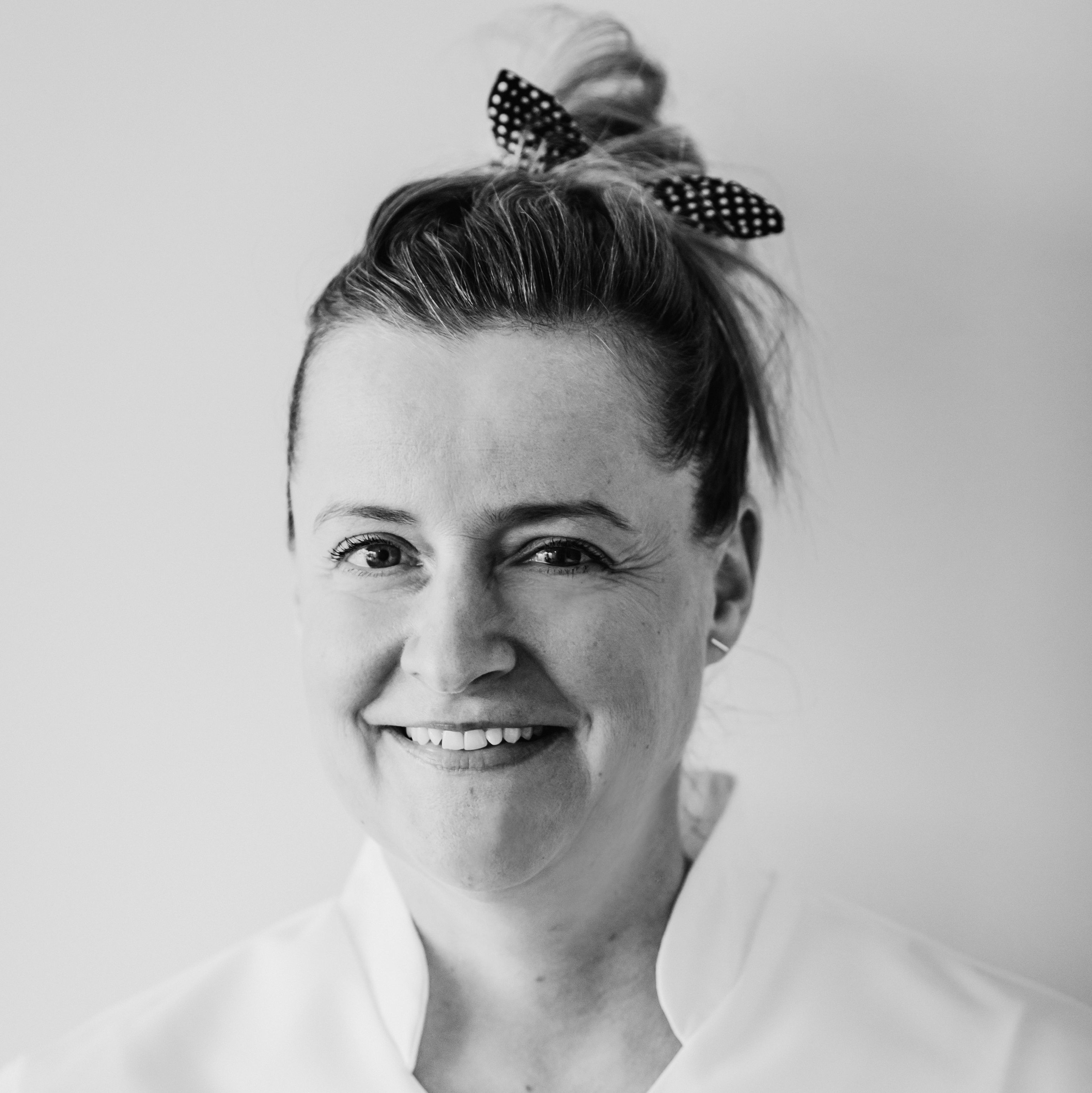 Black and white image of Anna smiling.