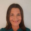 Woman on a white background wearing a green shirt.