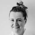 Black and white image of Anna smiling.