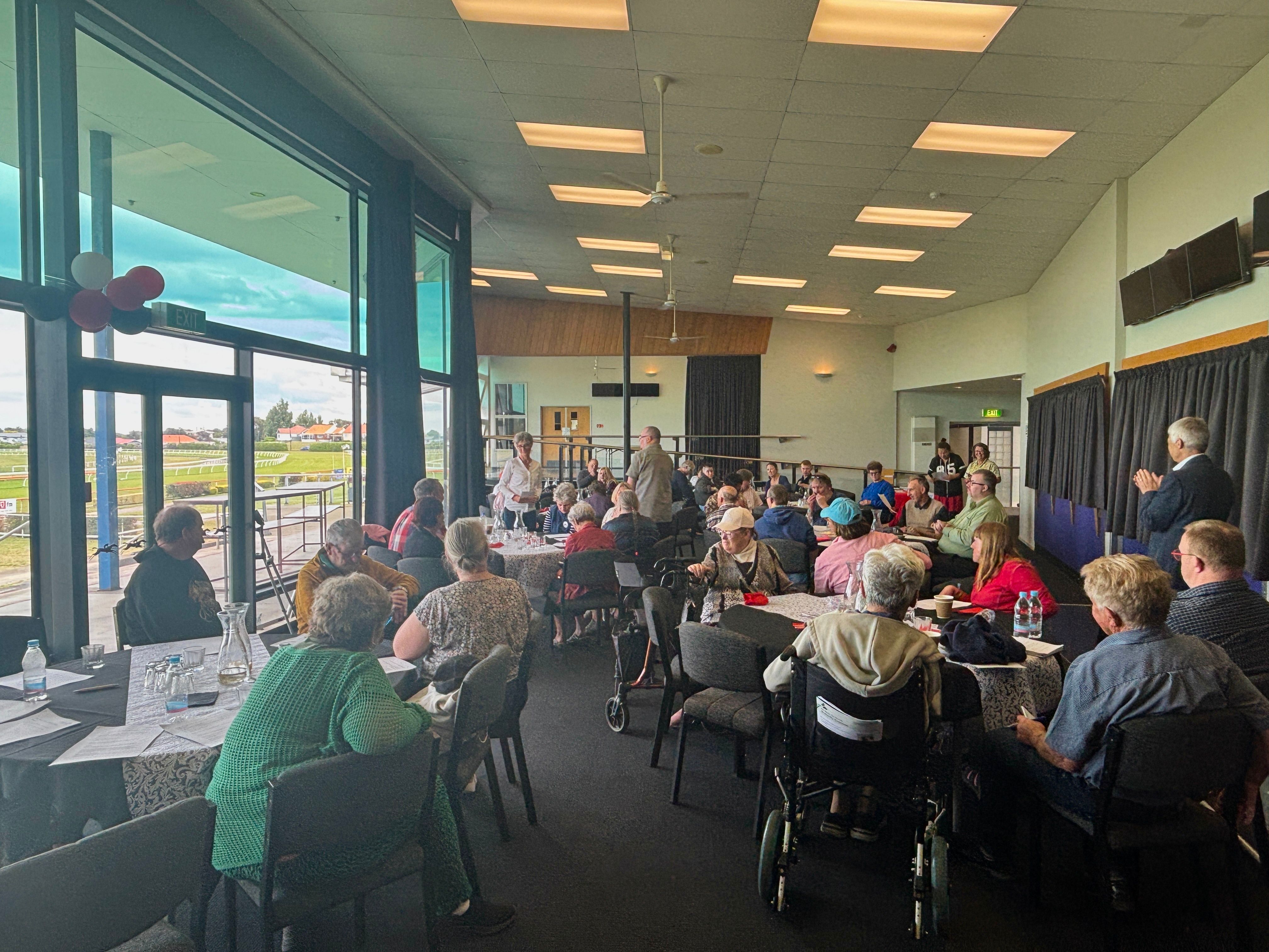 A group of people sitting around group tables.