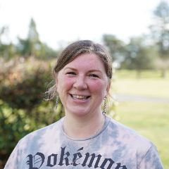 woman wearing a grey top smiling