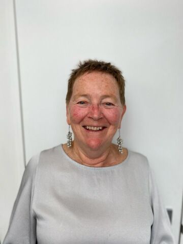 image of Alison with a grey shirt smiling.