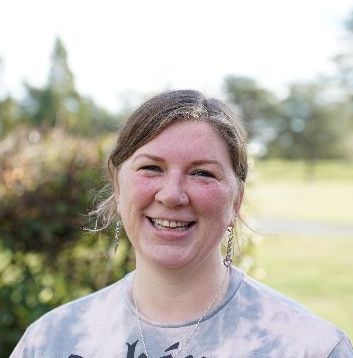 woman wearing a grey top smiling