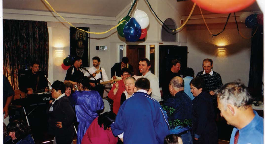 People dancing with a band playing in the background.