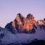 the sun is shining on the snow covered mountains at sunset .