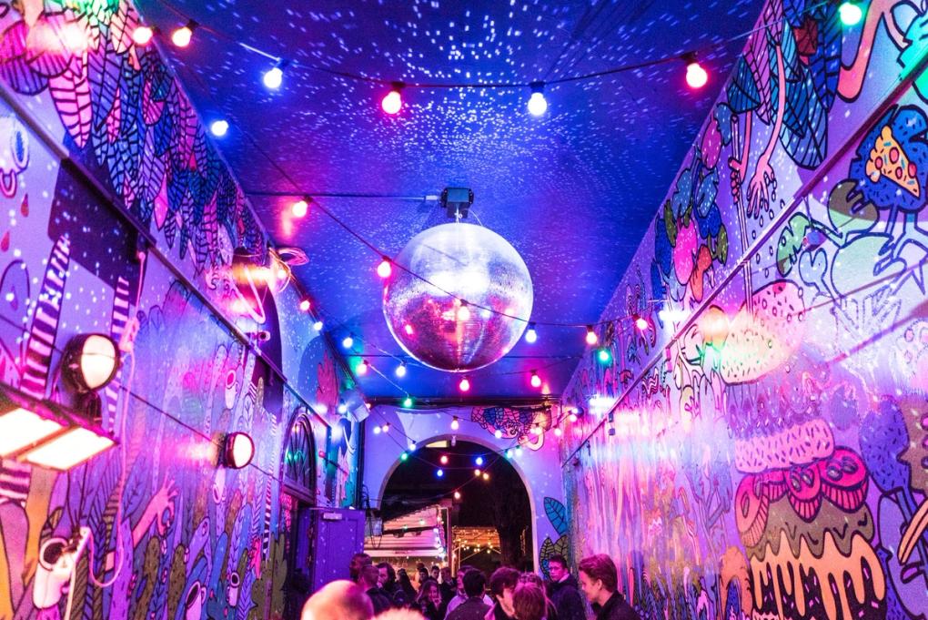 a disco ball is hanging from the ceiling of a building