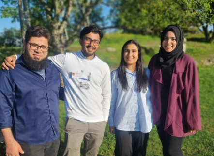 A group of students smiling and posing together for a photo.