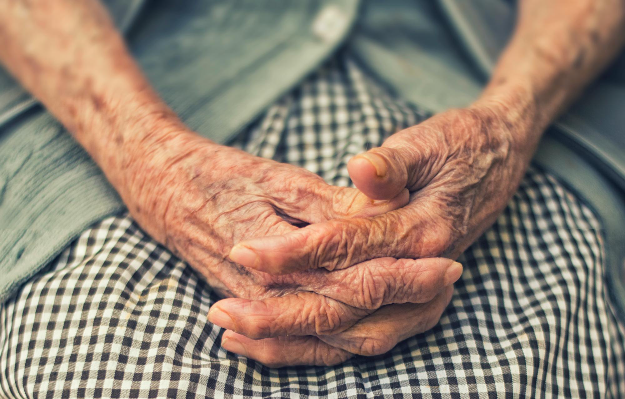 Old, folded hands.