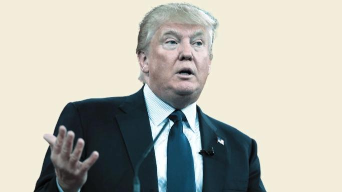 Donald Trump speaking at a podium, gesturing with his hand.