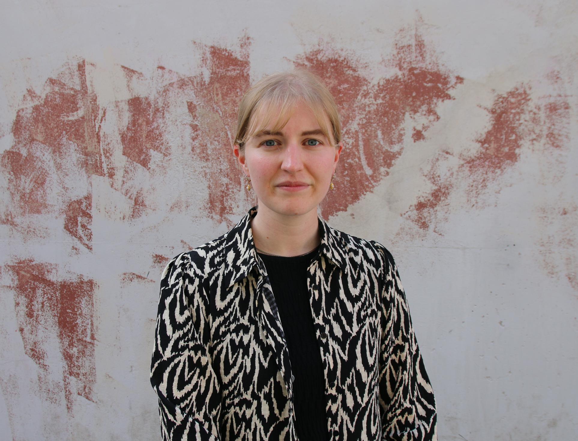 A woman wearing a black and white animal print shirt.