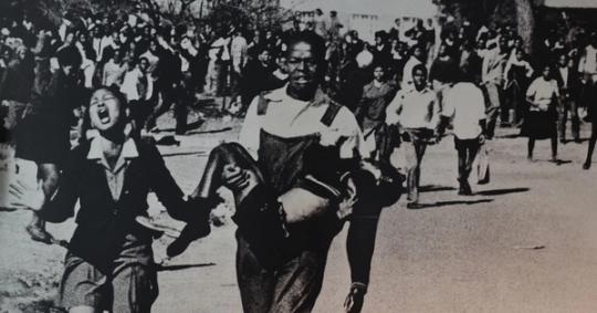 Mbuyisa Makhubu carries a dying Hector Pieterson, with Antoinette Sithole screaming beside them, during the Soweto Uprising.