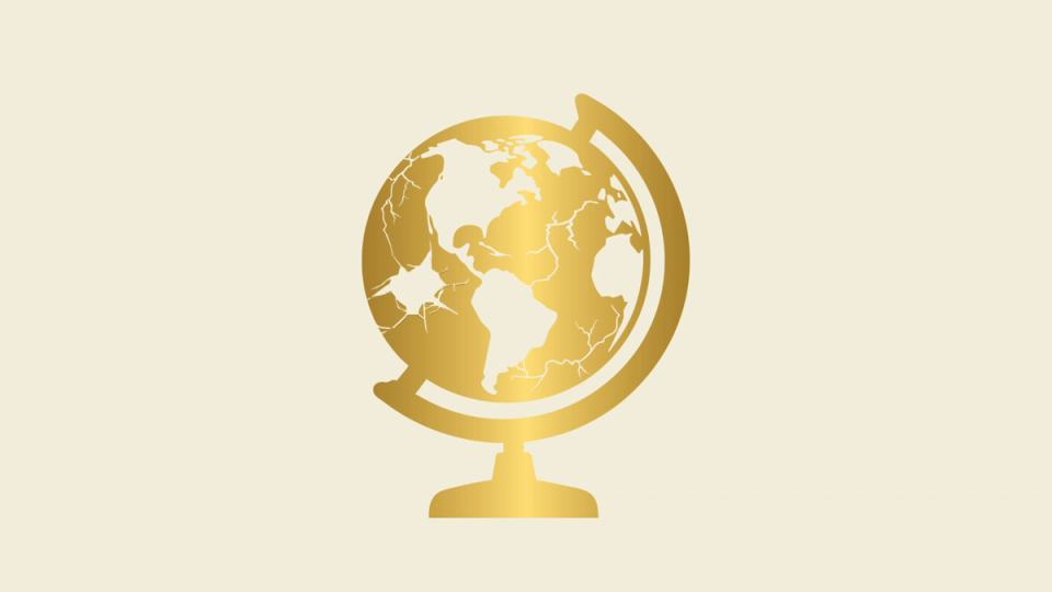 a gold globe with a map of the world on it