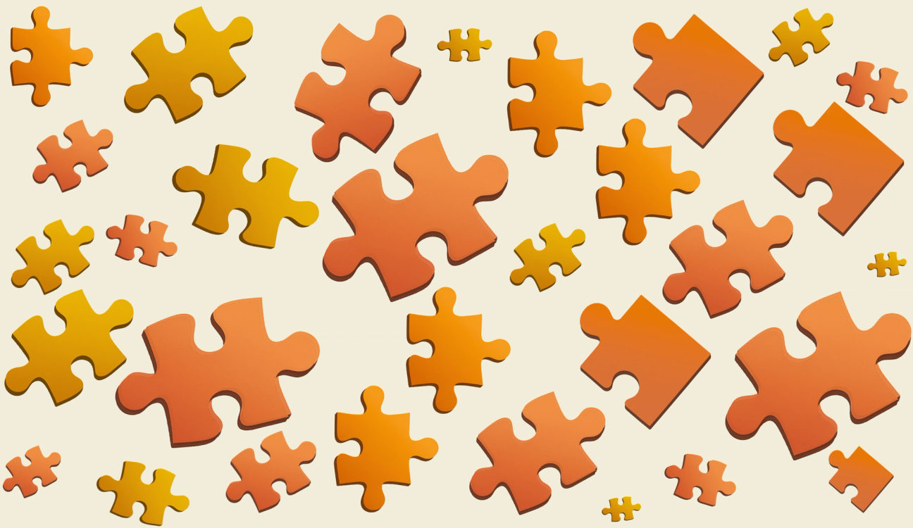 Scattered orange and yellow puzzle pieces on a light background.