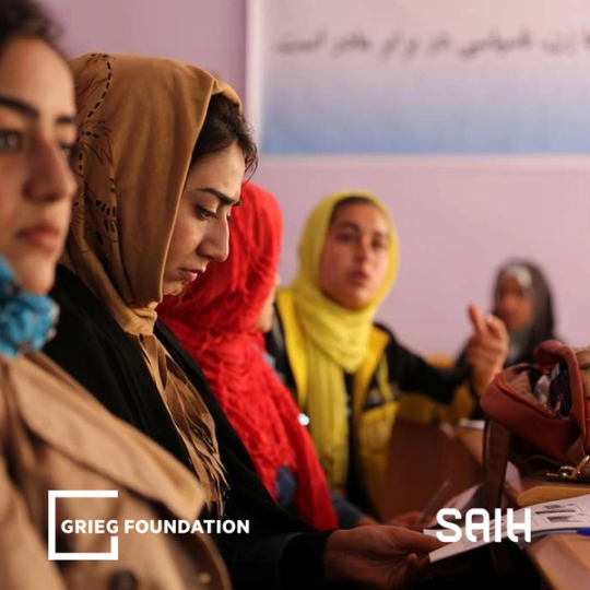 a group of women sit in a classroom with grieg foundation written on the bottom