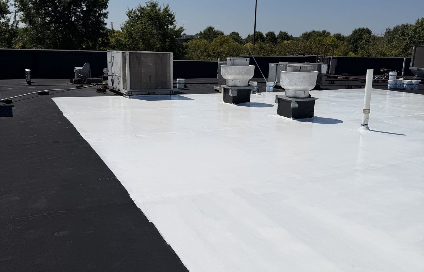 White silicone coating over the grease zone of an EPDM roof
