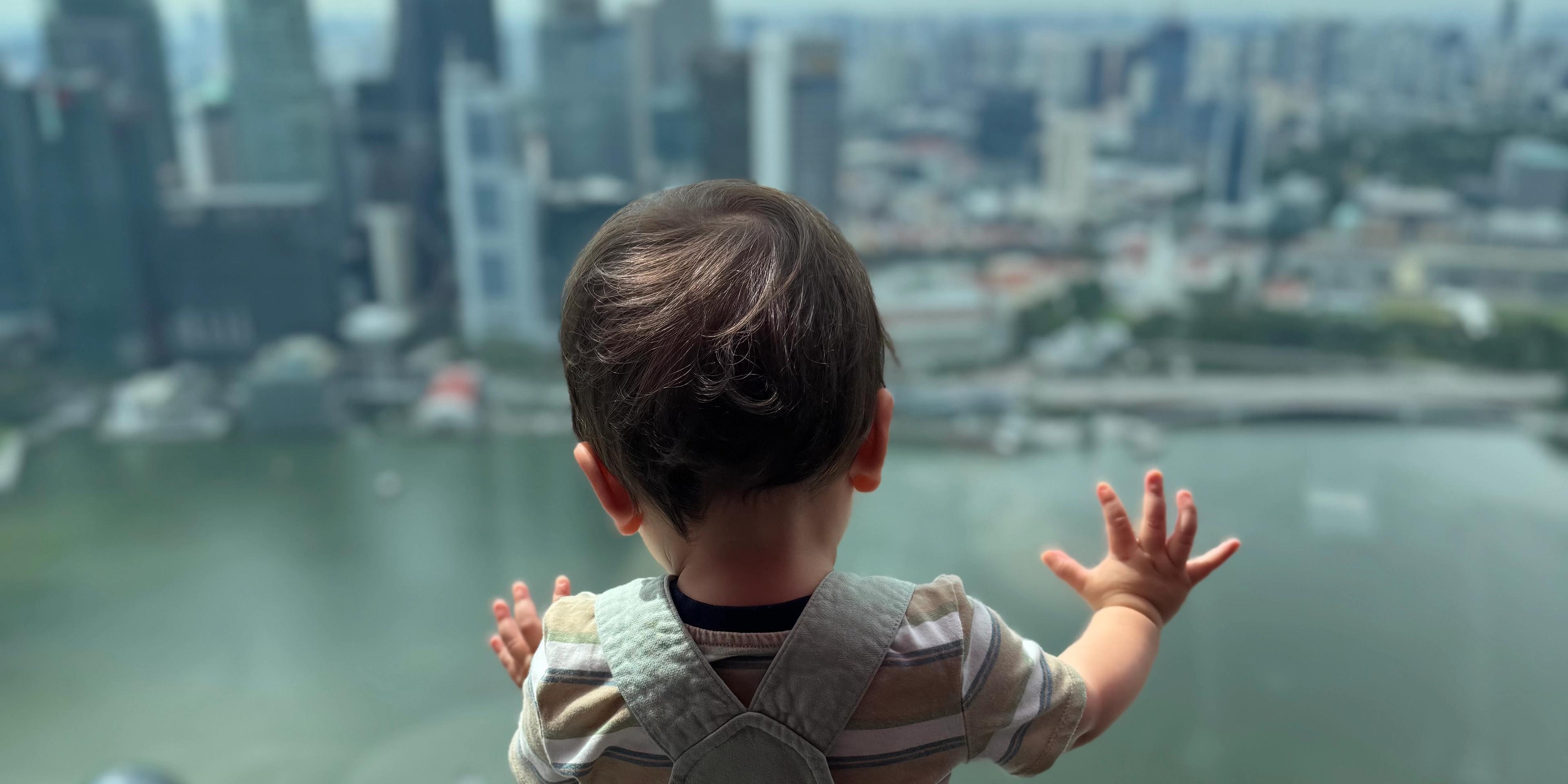 Toddler visiting Singapore with photo at the Merlion near Marina Bay