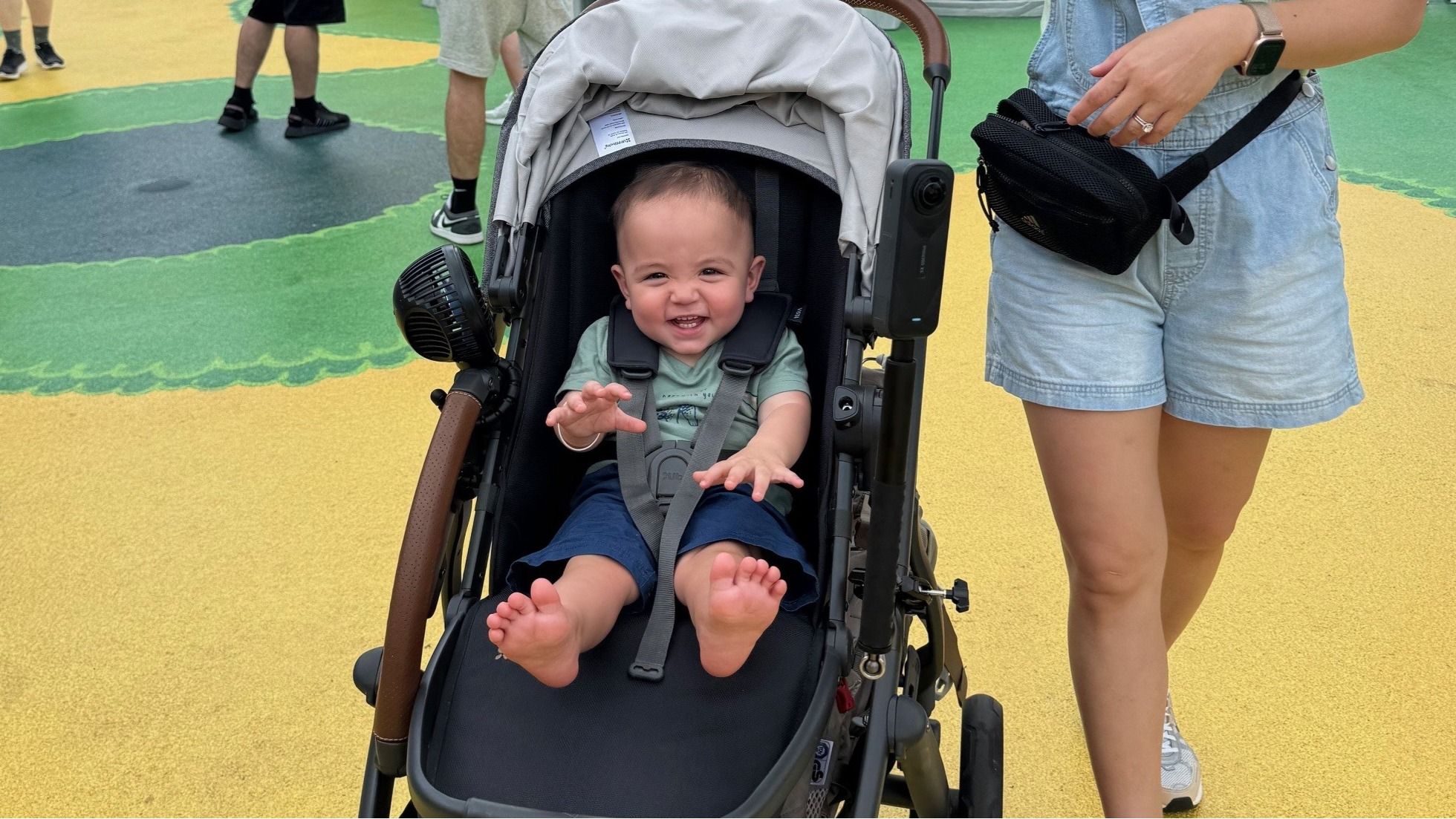 One-year-old in a stroller zipping through Super Nintendo World at Epic Universe—colorful pipes and ? blocks in the background