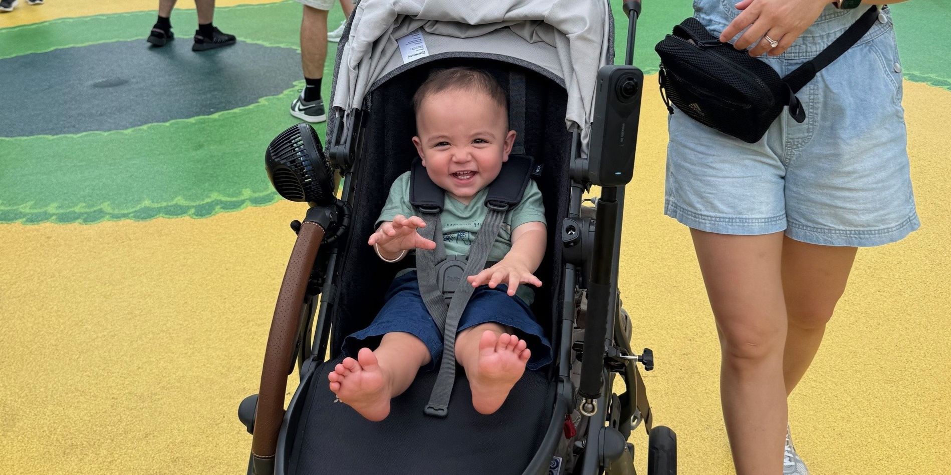 One-year-old in a stroller zipping through Super Nintendo World at Epic Universe—colorful pipes and ? blocks in the background