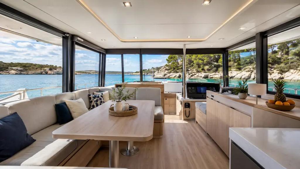 Bright catamaran saloon at deck level with windows on three sides