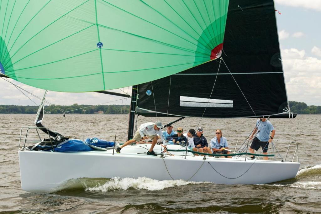 Adults taking a beginner sailing lesson