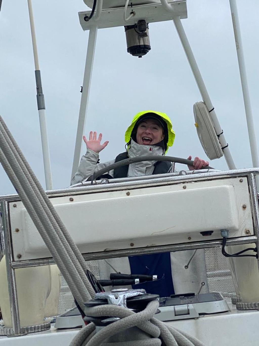Elouise at the helm in heavy weather kit