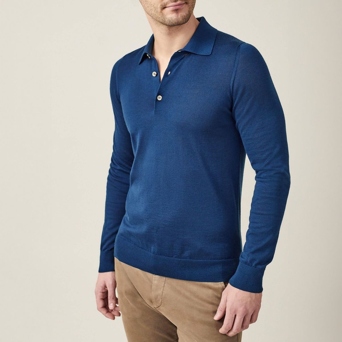 Luca Faloni blue polo styled with neutral trousers