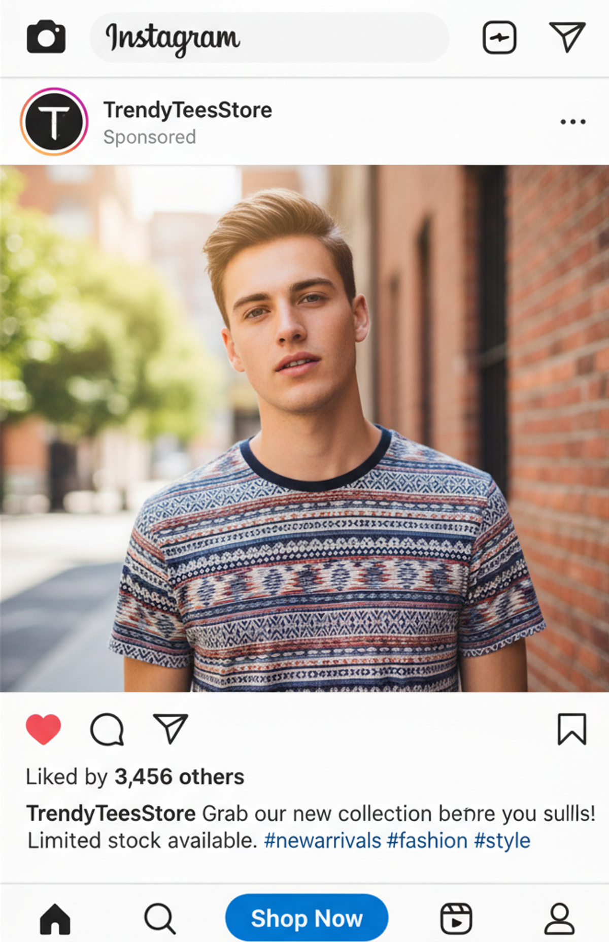 Instagram sponsored ad post for TrendyTeesStore showing a young man with blonde hair wearing a short-sleeved t-shirt with a blue, red, and white patterned design, standing outdoors near a brick wall.