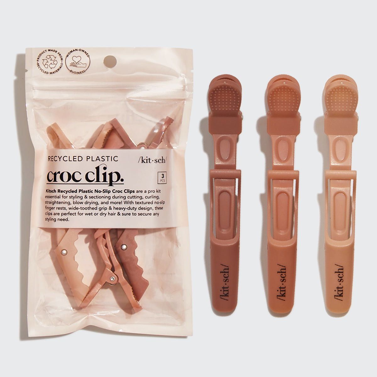 Kitsch croc-clip ad displaying three clips beside their product packaging.