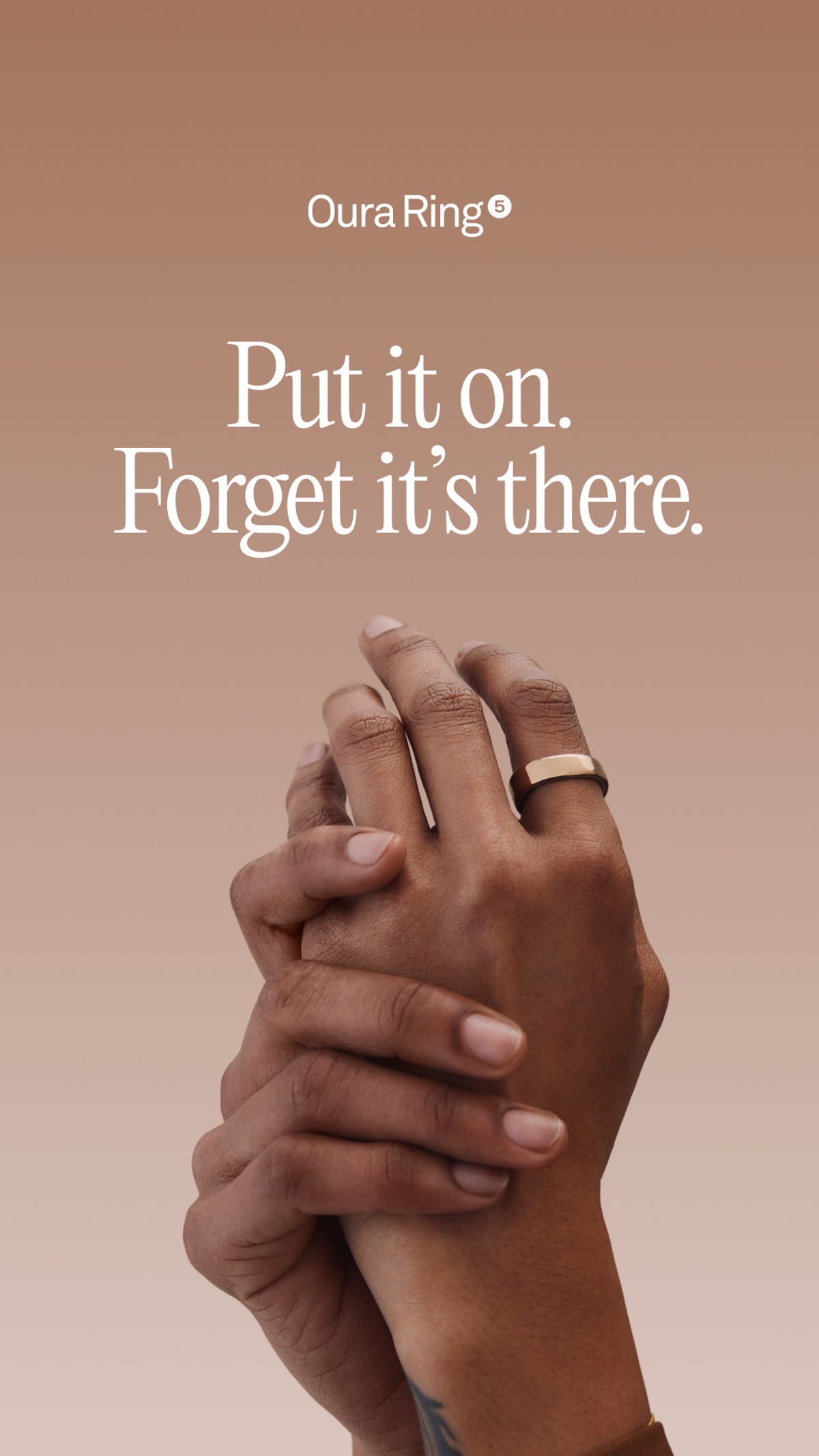 Oura Ring ad showing a ring on a hand beneath the message Put it on. Forget it is there.