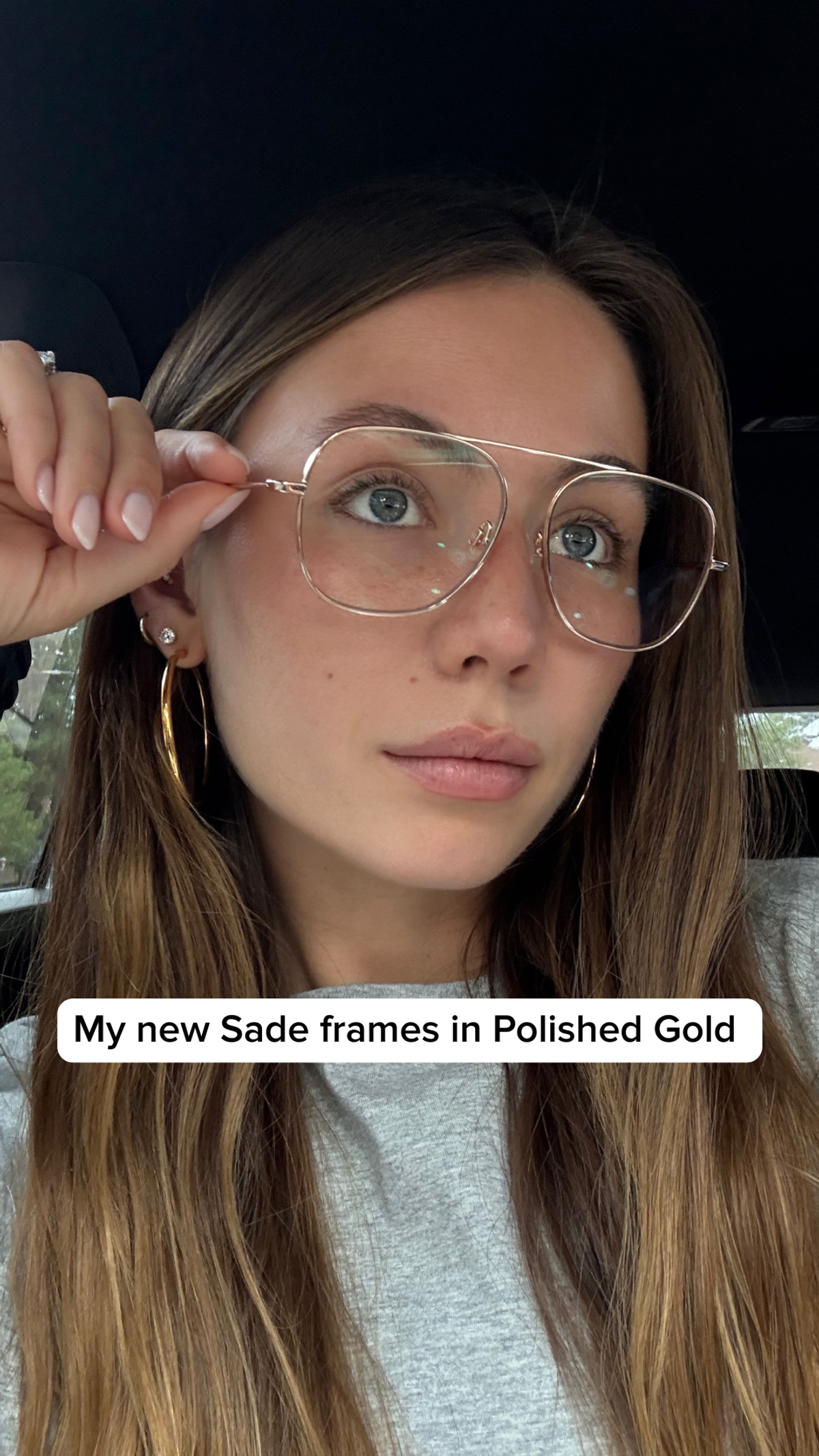 Warby Parker ad showing a person wearing Sade frames in Polished Gold
