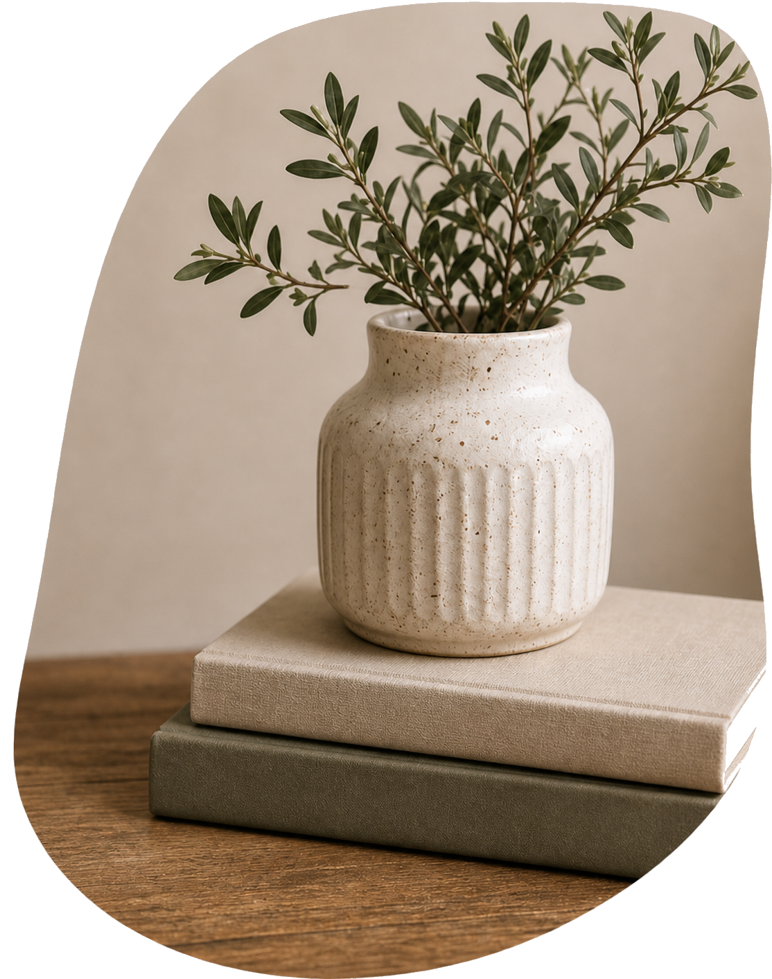 Ceramic vase with branches beside stacked books