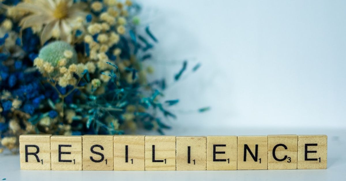 a scrabble type block spelling the word resilince