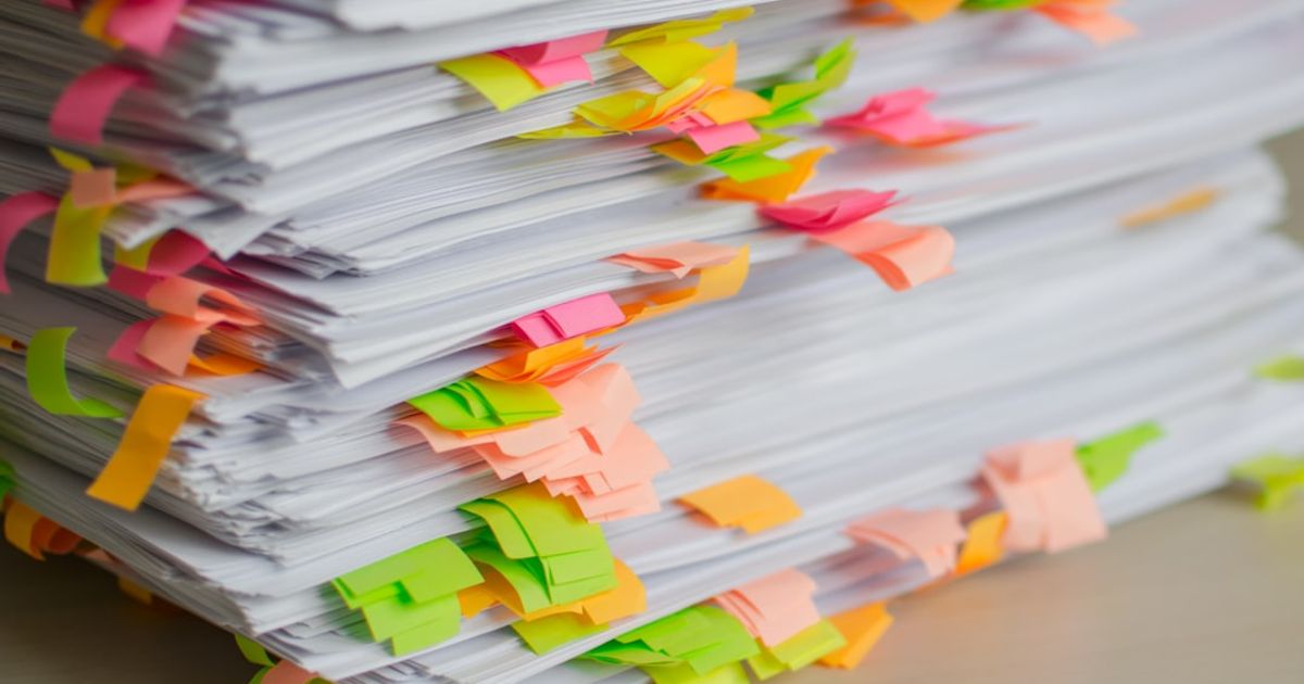 Stack of papers marked with colorful sticky tabs