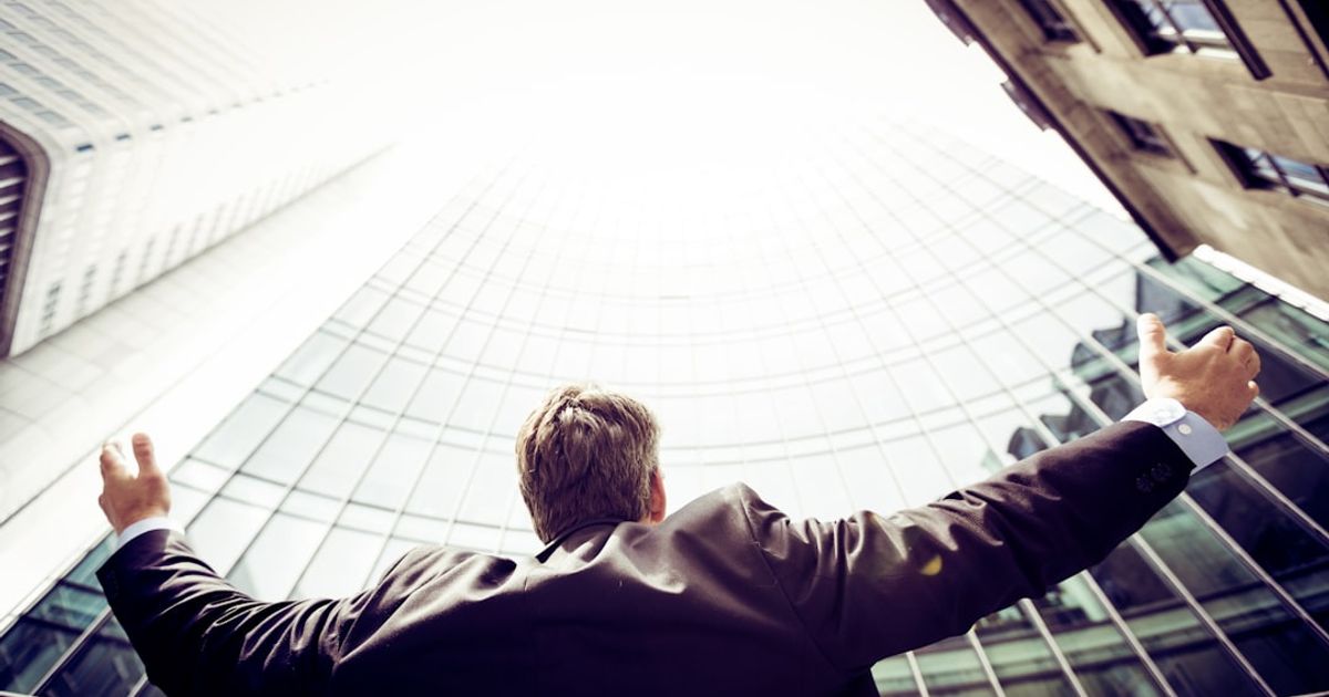 low-angle photography of man in the middle of buildings