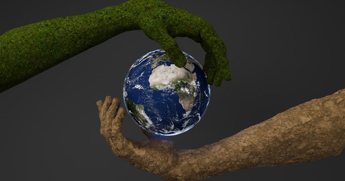 Two hands are holding a small earth globe