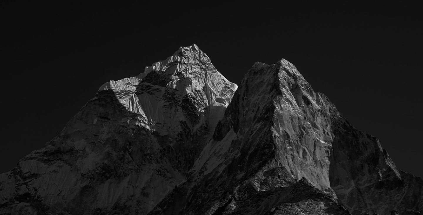 Dark mountain peak against a black sky, representing the category default in employee feedback platforms