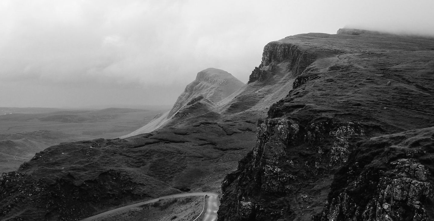 Long road winding through dark hills, representing the distance between events and quarterly engagement data