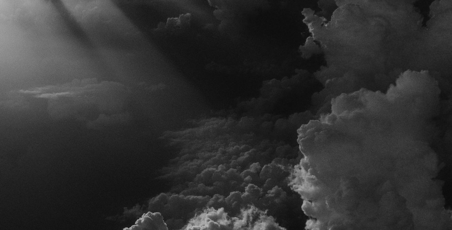 Storm clouds gathering with light breaking through, representing the warning signs of burnout before resignation