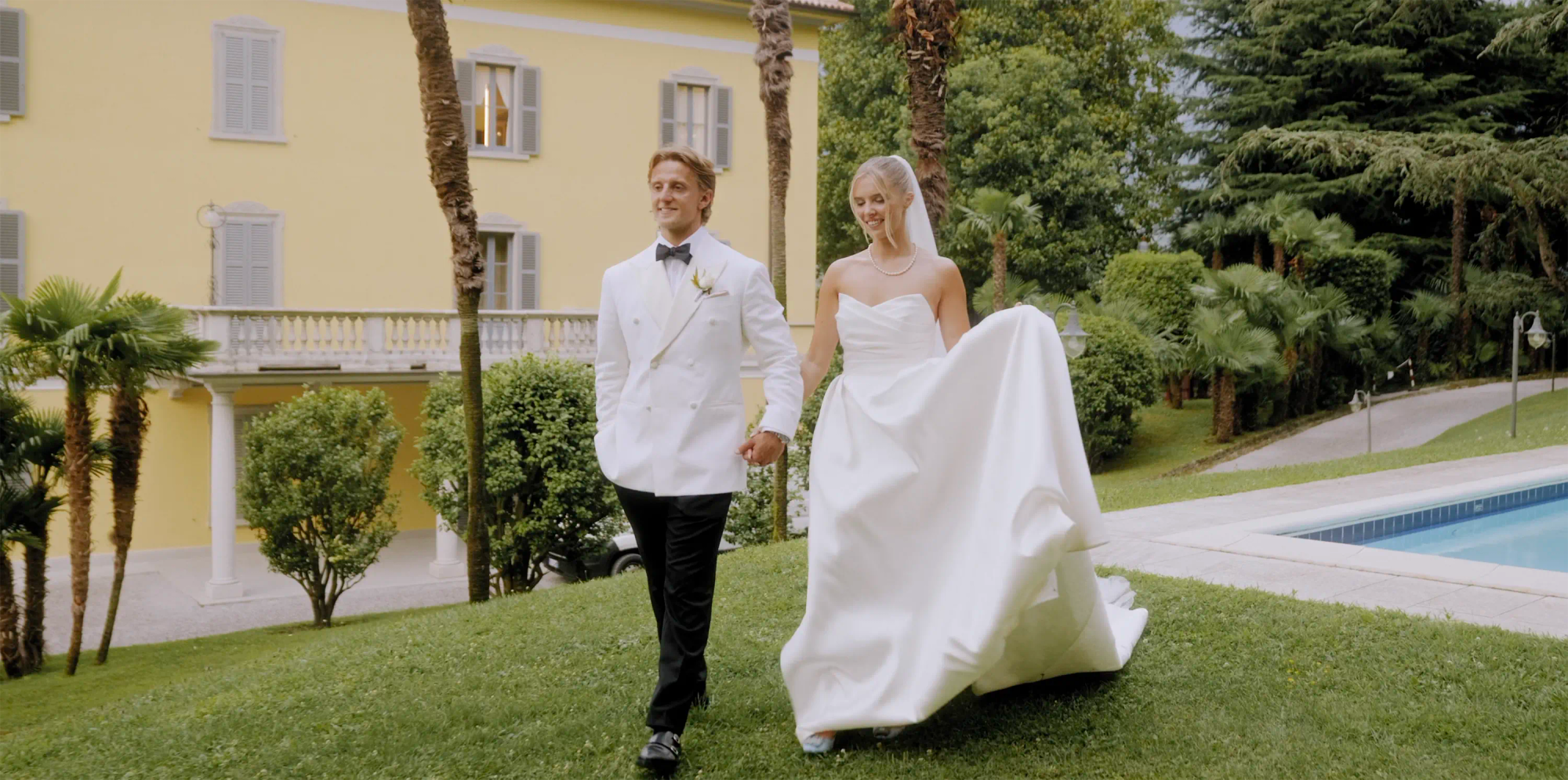 Couple walking together beside Lake Como