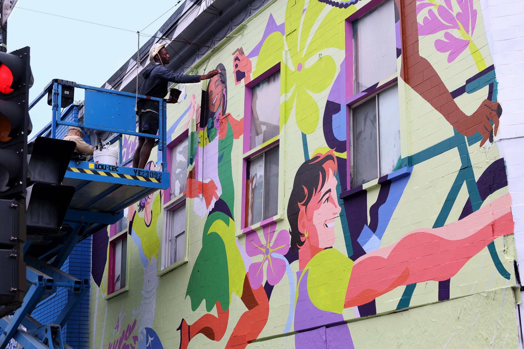 Artist painting KOHO mural at Montreal MURAL Festival