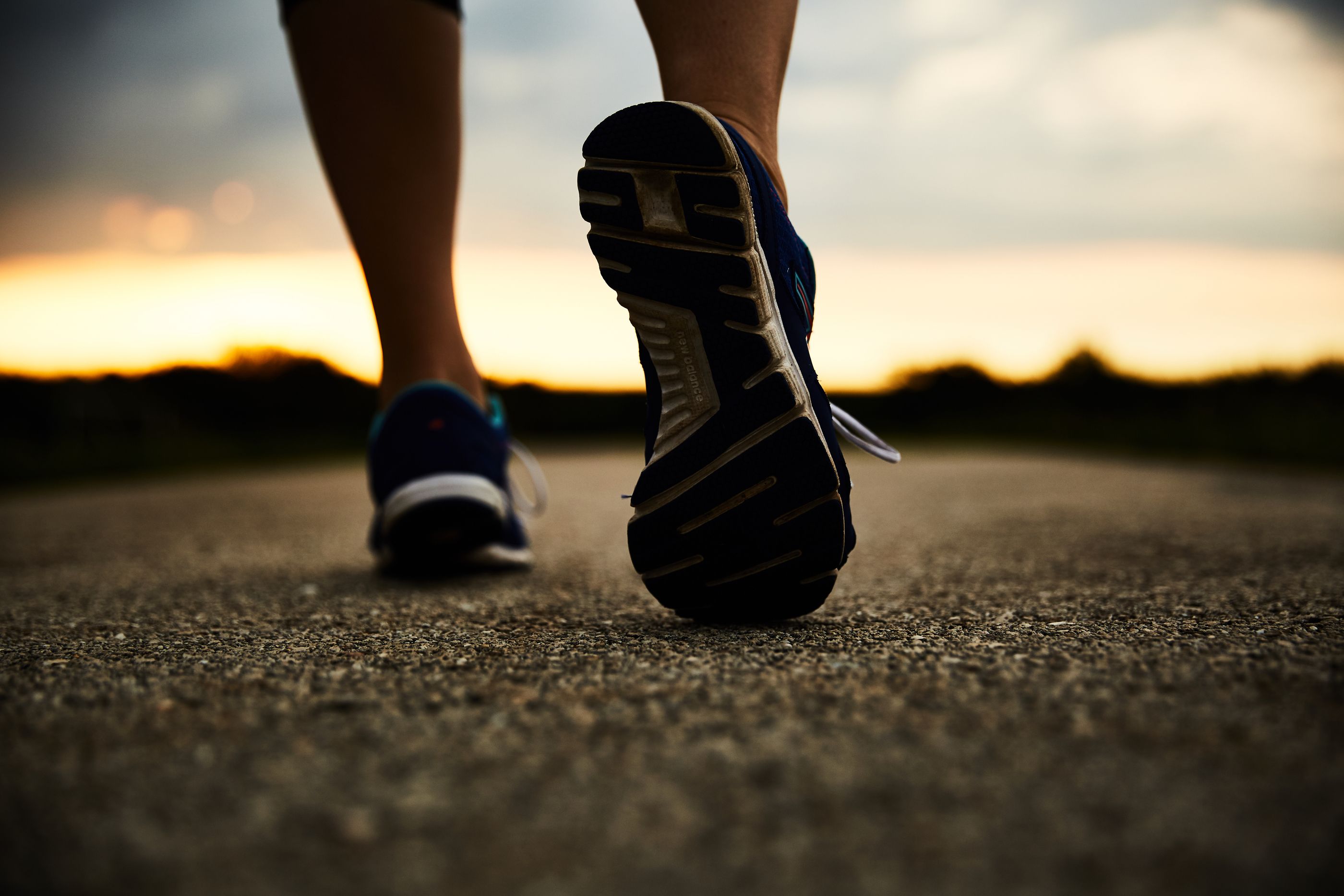 Person walking on a path, zoomed in on sole of shoes