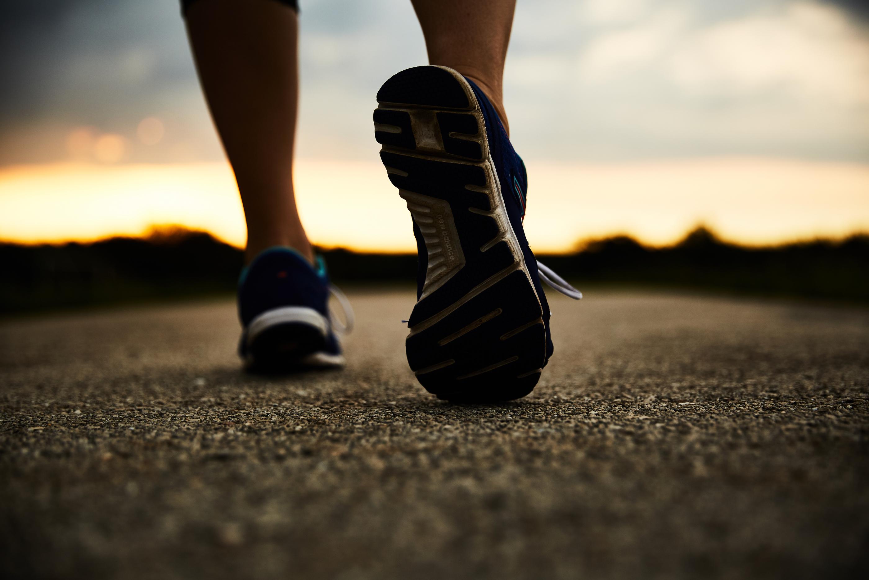 Person walking on a path, zoomed in on sole of shoes