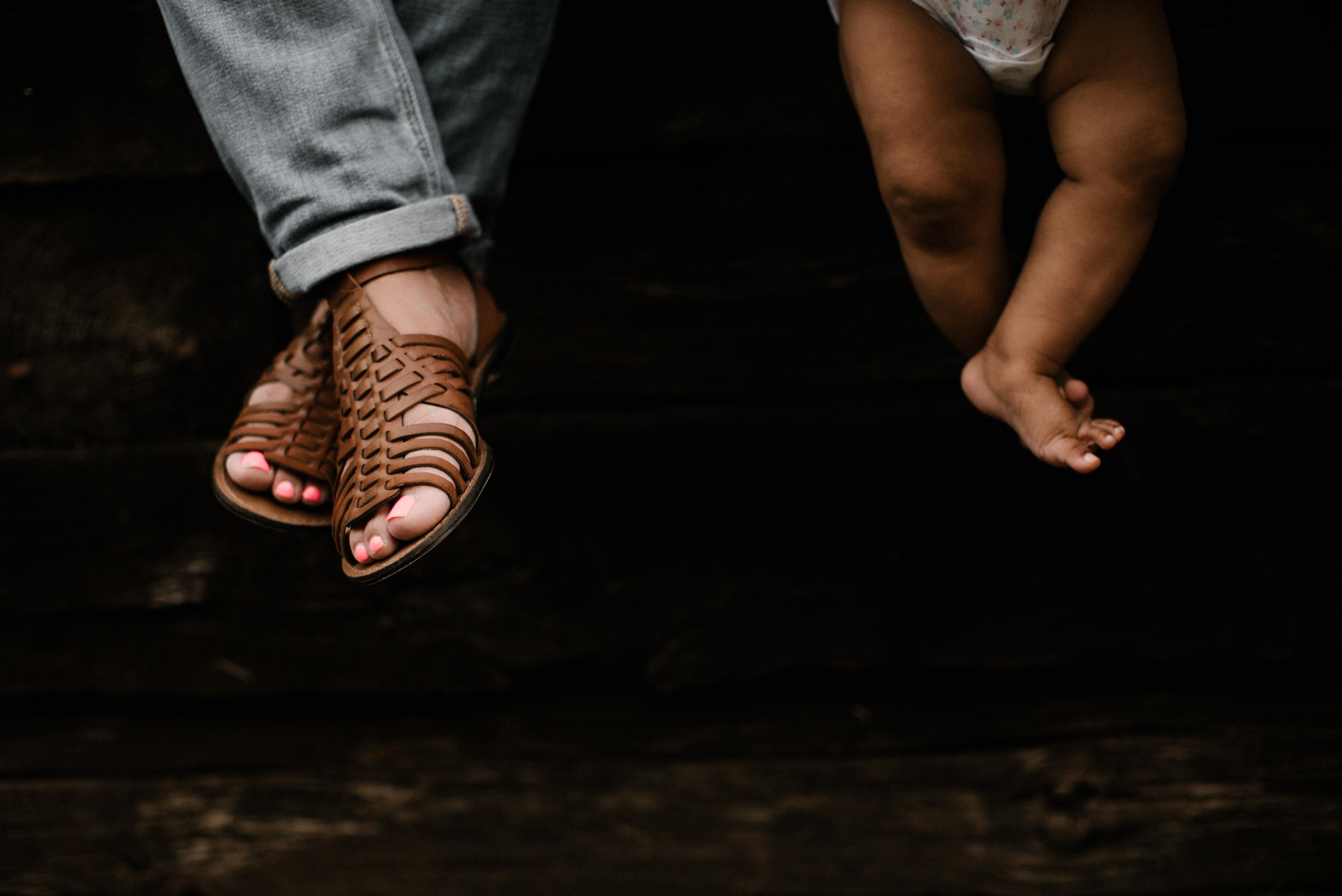 Woman and Childs feet, sitting together