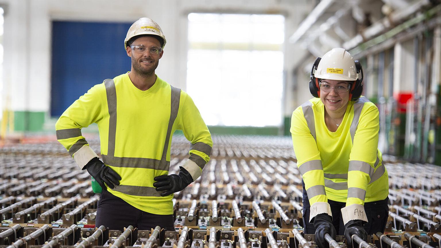 Two workers standing in an industrial setting
