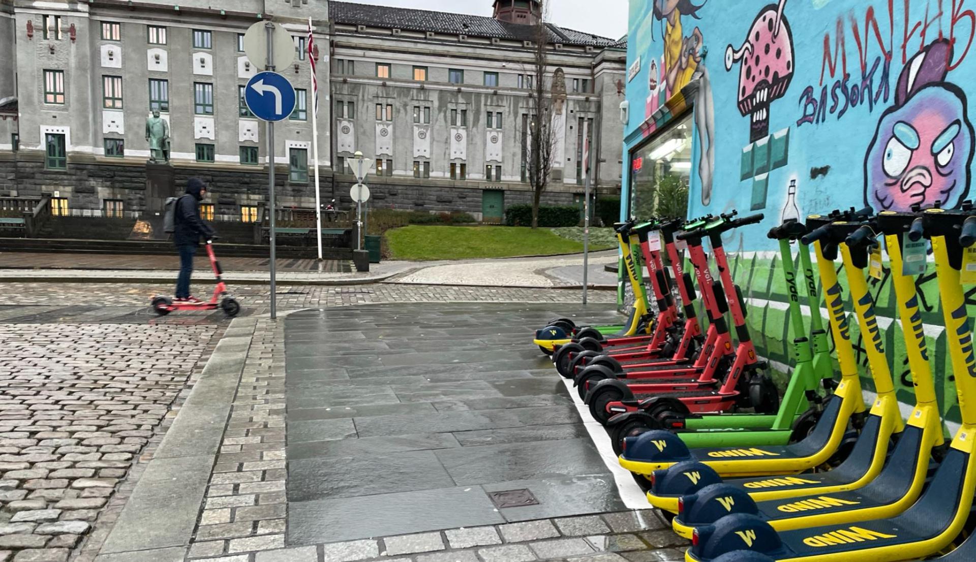 bergen with nicely parked scooters outside theater colourful background