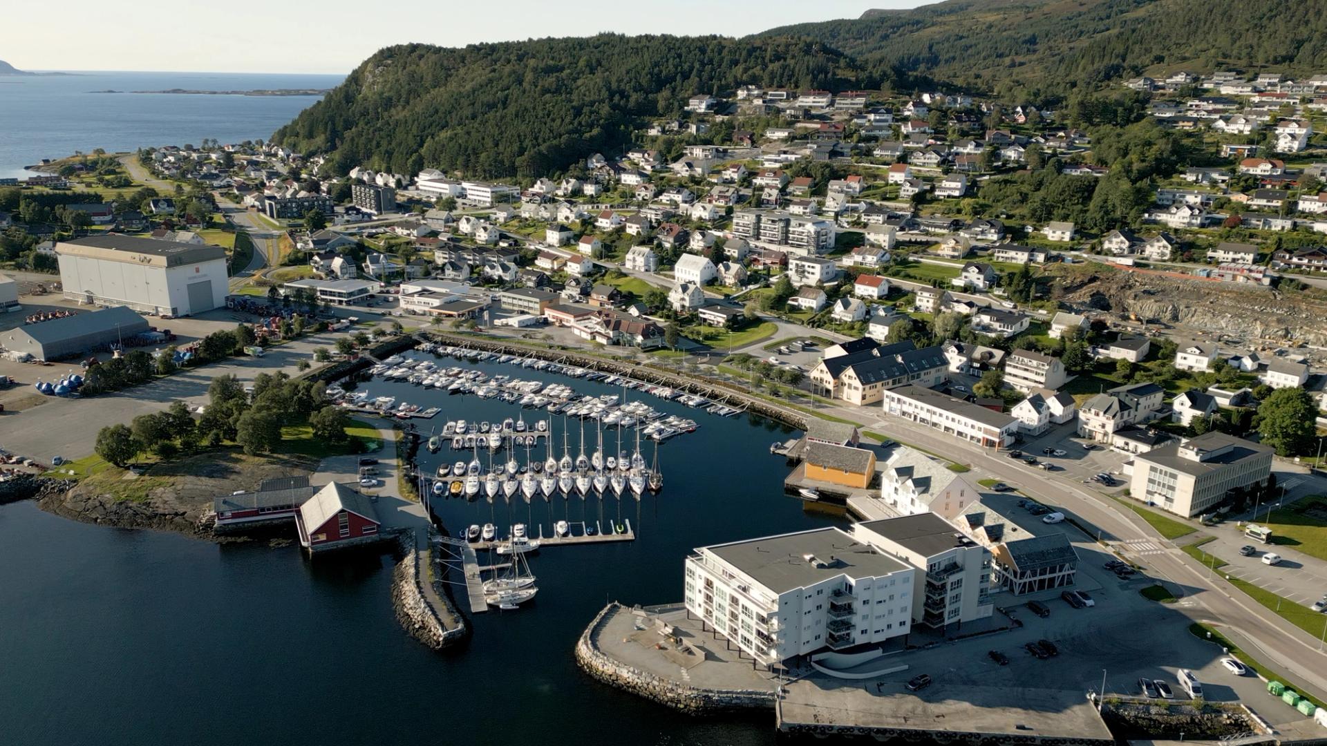 Norwegian coastal town with white houses and a marina