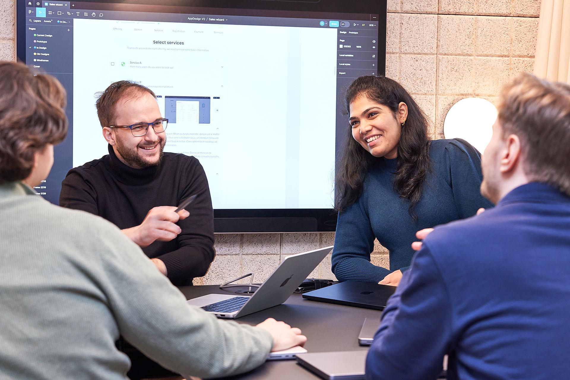 4 mployees talking and smiling.