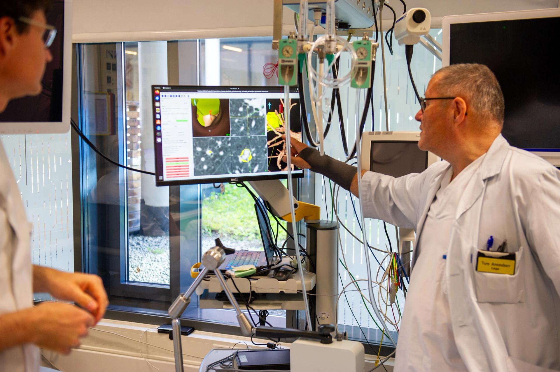 Two doctors looking at MRI images while planning neurosurgery