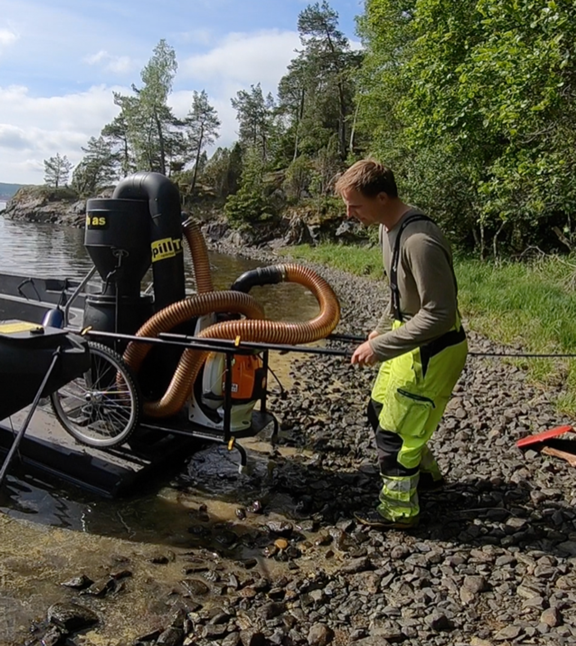 man operating an outdoor vacuum cleaner for plastic waste